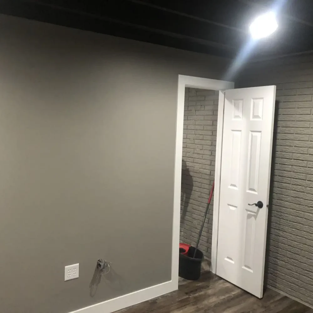 Basement Remodel with White Finishes and Beige Walls